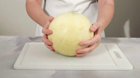 Honeydew melon close up on cutting board, woman hands Stock Footage 168848251