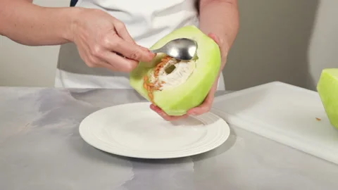 Honeydew melon close up on cutting board. How to peel and seed melon Stock Footage 168853673