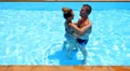 Honeymoon Happy Young Newlyweds Flirting and Spinning in Pool. HD Footage