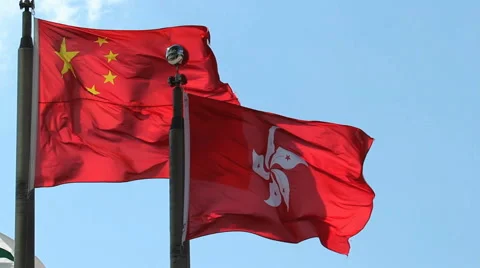 Hong Kong and People's Republic of China Flags flying against clear blue sky Stock Footage 40480341