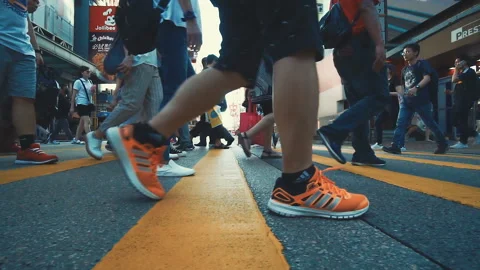 HONG KONG, CHINA - CIRCA JULY , 2018: Slow moving people pedestrians crossing Stock Footage