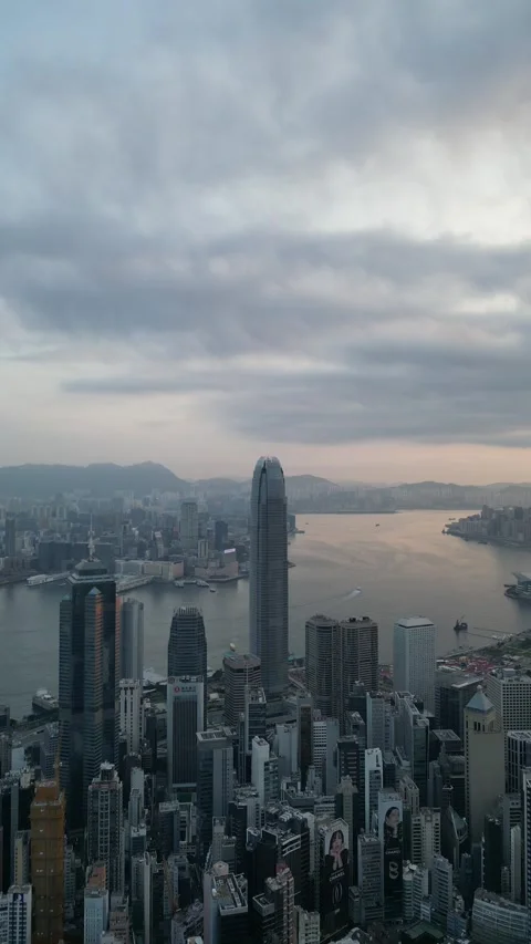 Hong Kong Cityscape with Clouds Moving Over the Victoria Harbour in Hong Kong Stock Footage 335810221