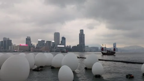 Hong Kong cityscape with floating Easter egg art object, pan shot Stock Footage 271191589