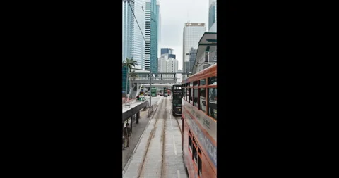 Hong Kong double-decker tram moving through urban city center Stock Footage 344457276