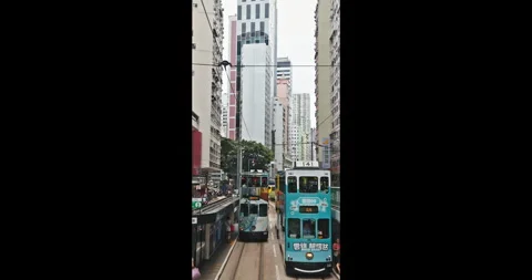 Hong Kong double-decker trams moving on city street Stock Footage 345268255