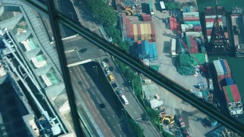 Hong Kong - Elevated view of industrial port and motorway reflecting in glass. Stock Footage 81704546