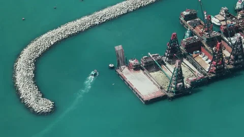 Hong Kong - Elevated view of industrial port. Close up of small boat passing by. Stock Footage 81977484