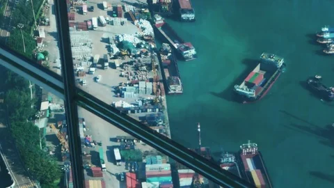 Hong Kong - Elevated view of industrial port reflecting in glass of skyscraper. Stock Footage 82176845