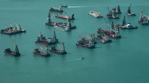 Hong Kong - Elevated view port with crane vessels and small boat passing by. Stock Footage 81704958