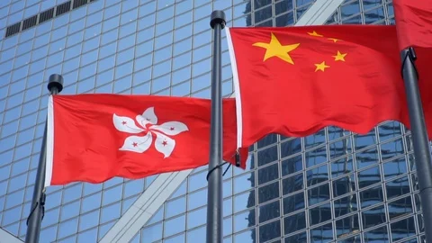 Hong Kong Flag Waving Next to China Flag with Modern Office Building in the Stock Footage 124677331