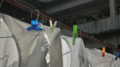 Hong Kong - Hanging sheets with typical residential building in background. 4K Stock Footage 70279151