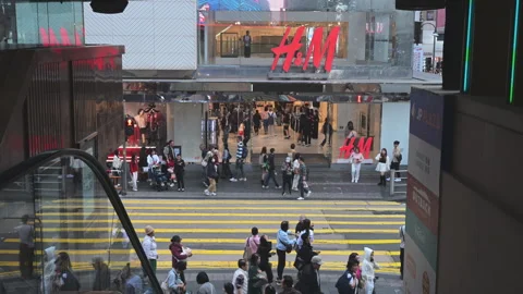 Hong Kong H&amp;M Storefront Crowds Crossing Street Global Fashion Retail Brand Stock Footage 335000925