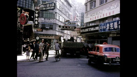 Hong Kong intersection with shops flatbed truck - 1960s Vídeo Stock 231199554