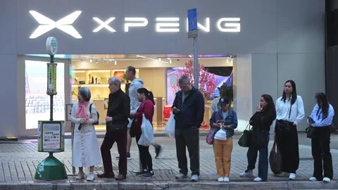 Hong Kong Night Commuters Queue Bus Stop Xpeng EV Dealership Modern Chinese Stock Footage 331117316
