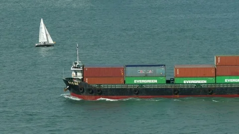 HONG KONG passing container ship with yaught 動画素材 70953820