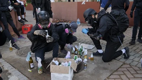 Hong Kong Polytechnic University Riots - Molotov Cocktail Builders Stock Footage 124862347