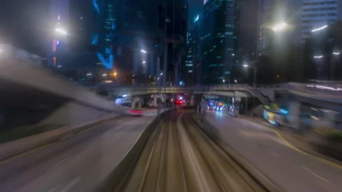 Hong Kong Tram Hyperlapse Through Vibrant City Streets at Night with Motion Blur Stock Footage 343154509