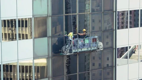 Hong Kong - Workers on suspended platform of high rise building. 4K resolution Stock Footage 81367799