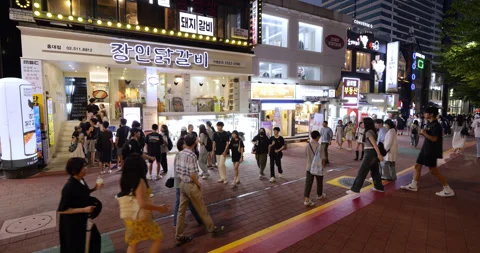 Hongdae Street in evening, line forms outside popular restaurant for dinner Stock Footage 292922014