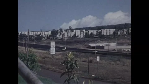 HONOLULU - 1978: Post housing - A round window breaks a white fence row Stock Footage 343936833