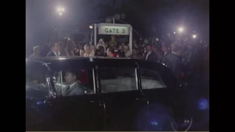 HONOLULU, HAWAII - 1966: Gate 3 motorcade - A limousine departs under lights Stock-Footage 344005051