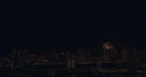 Honolulu Skyline at Night with Fireworks Exploding in Slow Motion Stock Footage 104371276
