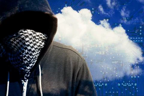 Hooded and masked computer hacker thief with a cloud computer based backgroun Stock Photos