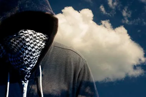 Hooded and masked computer hacker thief with a cloud computer based backgroun Stock Photos