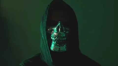Hooded hacker Cyber attacker in mask and hoodie watching camera Stock Footage 310361377