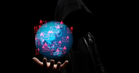 Hooded hacker hand holding a spinning earth globe with a spam virus email symbol Video stock 337428778