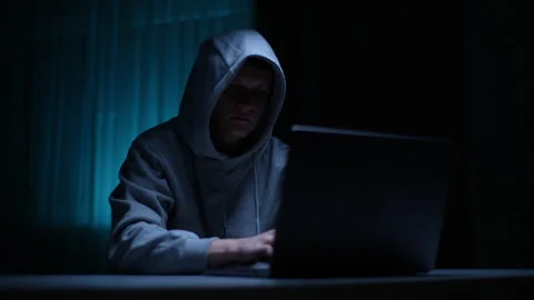 Hooded hacker male getting access to computer system, hacking into database Stock Footage 266123082