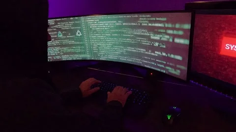 A hooded hacker programs lines of code and moves the mouse. 스톡 동영상 283592465