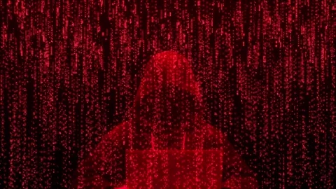 Hooded Hacker Silhouette Working on Laptop with Red Digital Binary Code Rain Stock Footage 337879897