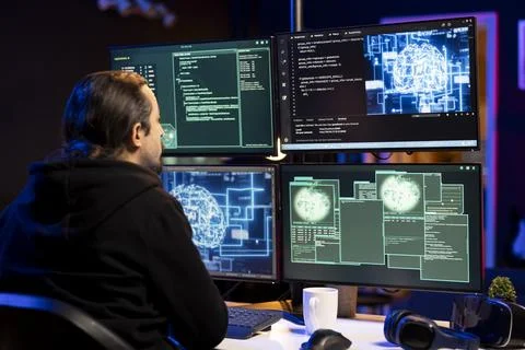 Hooded hacker using AI machine learning to bypass firewalls Foto stock