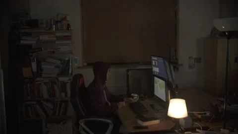Hooded Hacker Working on Computer in Dark Room Stock Footage 344625158