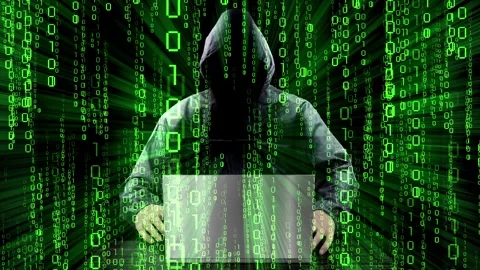 Hooded hacker working on computer, matrix effect binary code 動画素材 314199572