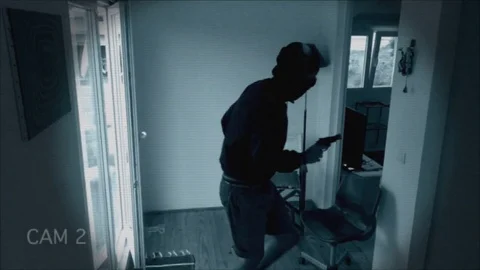 Hooded Man With Gun Breaks Into A House Stock Footage