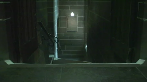 Hooded man walking up stairs Stock Footage