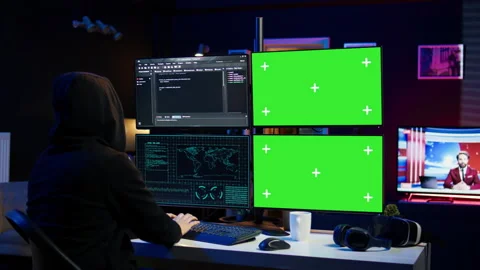 Hooded man writing lines of code on green screen PC from apartment 库存影片 275864842