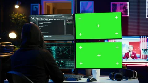 Hooded man writing lines of code on green screen PC from apartment Stock Footage 275865183