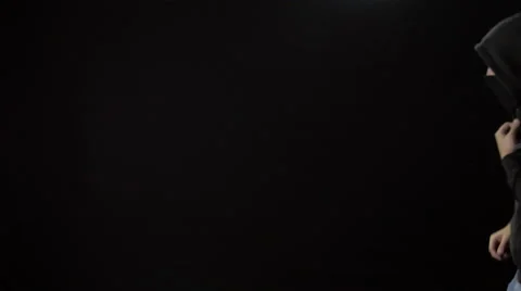 Hooded Masked Man Pulls an Assault Rifle Out of His Sweatshirt Stock Footage 61248491