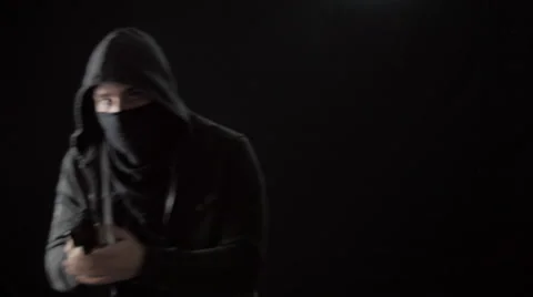 Hooded Masked Man Pulls Handgun Out of His Sweatshirt Stock Footage 61247140