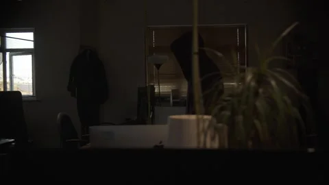 Hooded Person Walking Through Dark Office at Night Stock Footage 344625545