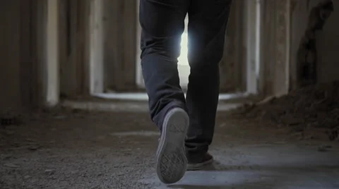 Hooded young man inside destroyed abandoned building,slow motion,dramatic Video stock 67248714
