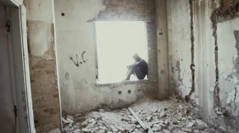 Hooded young man inside destroyed abandoned building,slow motion,dramatic Vidéo 67255232