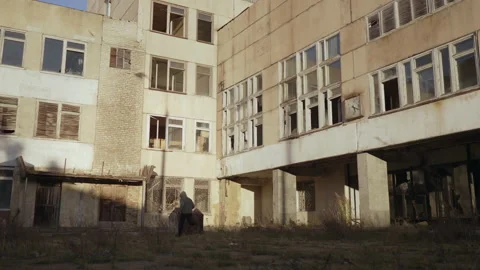 A hooded young man runs inside a ruined abandoned building, dramatically Stock Footage 227925558