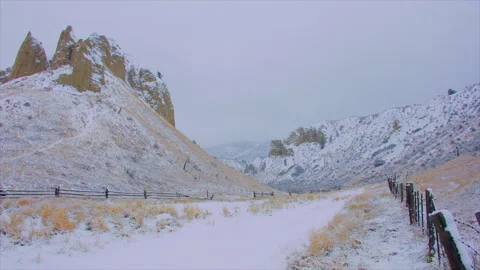 Hoodoos in small valley winter, dark sky, high key, 4k Stock Footage 253812832