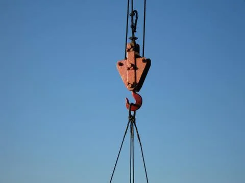 Hook of building crane lifting cargo Stock Photos