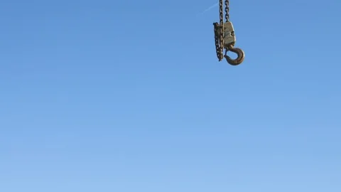 Hook chain hanging in front of blue sky Stock Footage 75170945