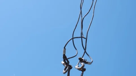 The hook of a construction crane hanging down from a boom on a clear sky Stock Footage 123871912